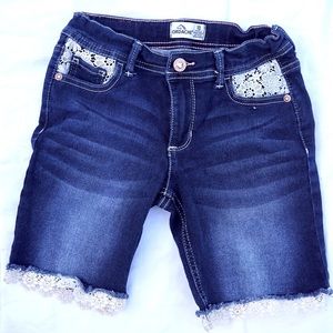 Cute girls’ size 10 Jordache dark denim shorts with lace trim.